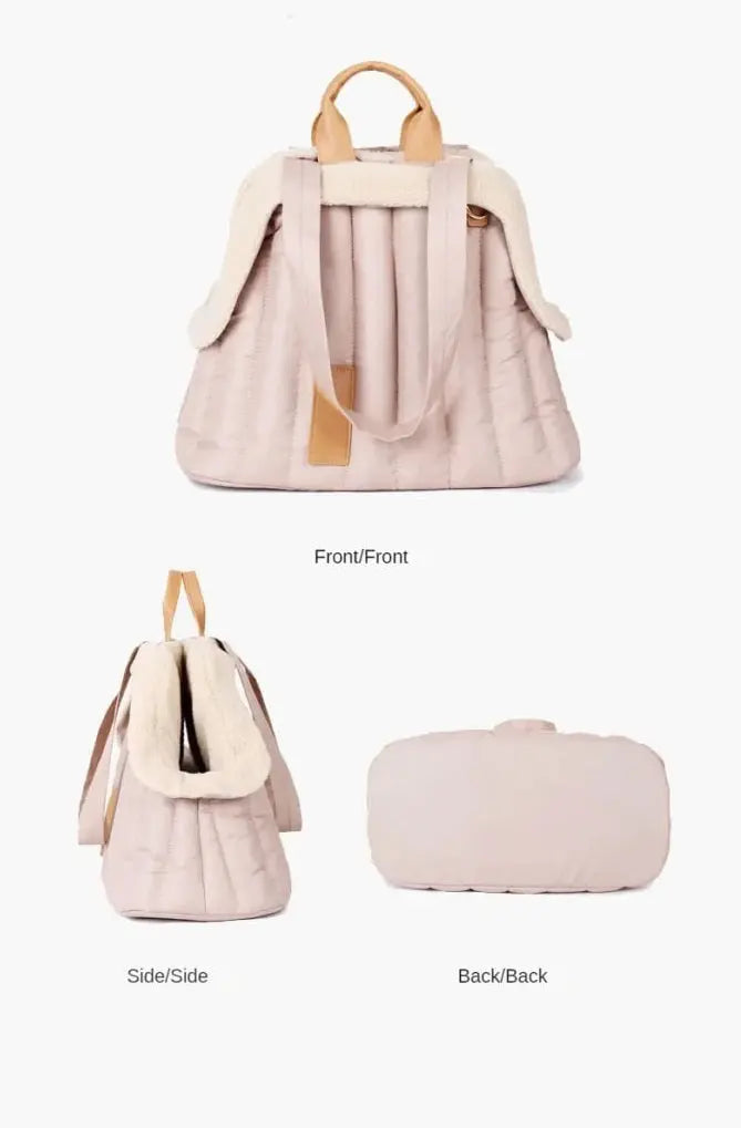 Pet handbag carrier with insulated material and soft plush lining for warmth and comfort.