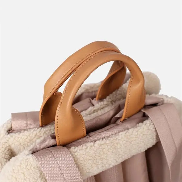 Pet handbag carrier with insulated material and soft plush lining for warmth and comfort.