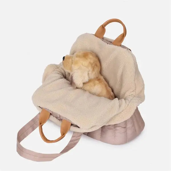 Pet handbag carrier with insulated material and soft plush lining for warmth and comfort.